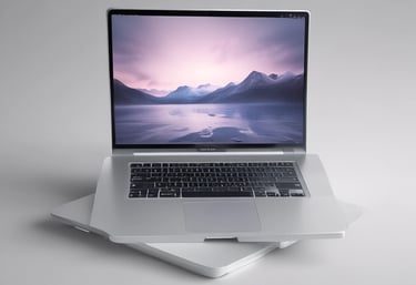 A friendly team collaborating over laptops in a bright, modern office space.