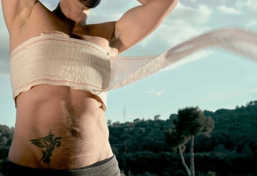 A person with a chest binder compression bandage outdoors, representing gender-affirming care and post-surgery recovery.