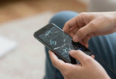 Technician carefully repairing a smartphone at a cozy workshop desk.