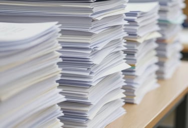 Close-up of hands stamping and legalizing official papers with a seal.