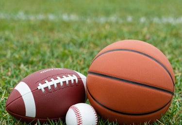 A set of high-quality running shoes and a water bottle on a wooden bench in a park.