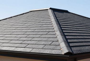 A close-up photo of a perfectly finished dark grey roof with modern tiling under the bright Southern African sun.