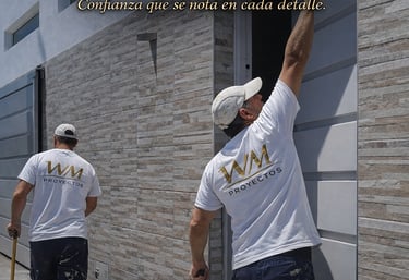 Professional contractors from Walter Martinez Proyectos performing home remodeling and painting services.