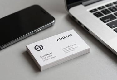 A focused shot of high-quality business cards with a minimalist design sitting next to a modern smartphone and laptop in a professional workspace.