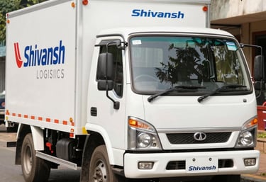 A fleet of modern trucks lined up outside a large warehouse facility under a clear sky.