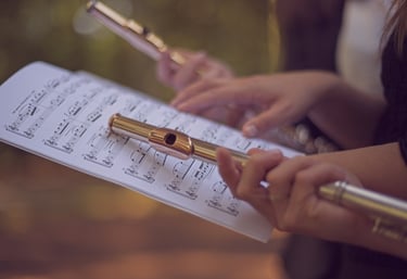 a person holding a flute and playing flute