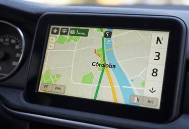 A close-up of a digital GPS navigation screen inside a vehicle showing a map of Córdoba, Argentina, representing efficiency and modern technology.