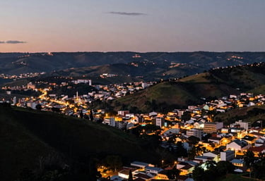 An outdoor shot of Teófilo Otoni landscape at dusk, showing the soft city lights and the surrounding hills of Minas Gerais, Brazil, in a professional cinematic style.