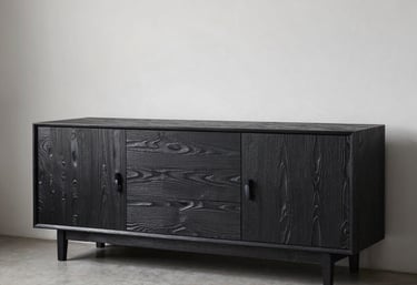 Interior design shot of a minimalist Dutch living room featuring a sideboard wrapped in a realistic dark wood-grain foil texture.
