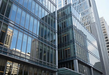 An architectural photography shot of a modern glass-walled corporate lobby in a major US city, clean lines, with Sky Blue reflections on the windows.