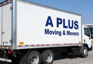 a plus moving & movers team loading a moving truck with packed boxes under sunny skies.