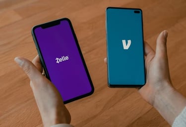 Person holding two smartphones displaying the Zelle and Venmo mobile payment app logos.