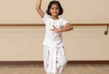 A cheerful child in colorful traditional dance attire practicing basic dance poses.