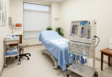 Kemet Oxy Clinic colon hydrotherapy room featuring an Aquaglush machine and medical treatment table.