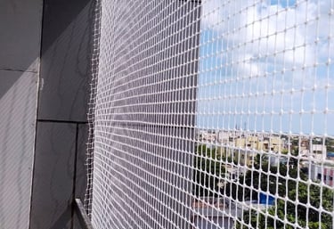 Close-up of a durable pigeon net installed on a Bangalore apartment balcony.