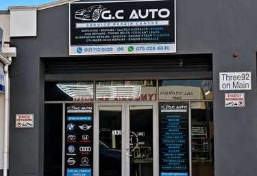 Exterior of G.C Auto Service Repair Centre building showing shop signage for engine repairs and car servicing.