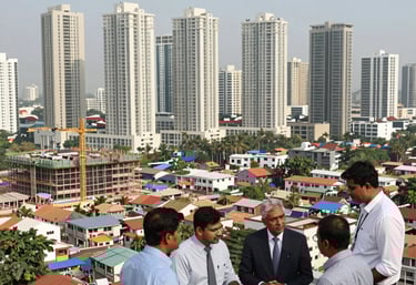 A professional team reviewing redevelopment plans around a conference table in a modern office.