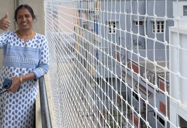 Close-up of a securely fitted safety net protecting a balcony from pigeons in a busy Bombay neighbor