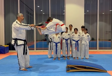 Master Carlos Bazan 7th Dan ITF Taekwondo instructor Dubai coaching student high kick