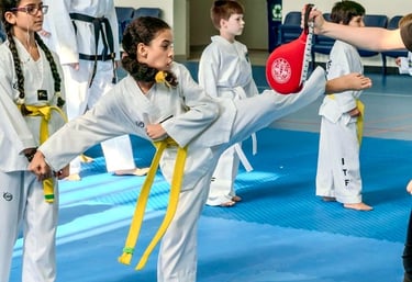 ITF Hwa Rang Yellow belt taekwondo student practicing kicking technique in Dubai