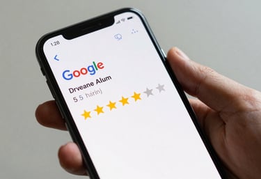 A smartphone held in a hand, showing a 5-star Google review notification on a clean white interface. The lighting is crisp, highlighting the trustworthy feedback.