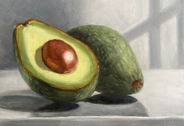 An original oil painting of avocado halves in the sunlight