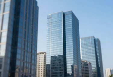 A modern cityscape with clean glass buildings reflecting a clear blue sky, symbolizing growth and professional success. Incorporates #3F6C8A and #9CC0D9 colors.