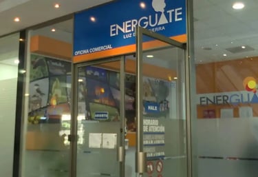 Energuate commercial office storefront with blue signage and business hours posted on glass doors.