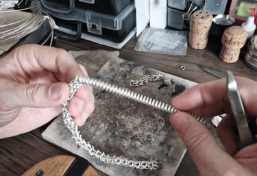 a person is holding a chainmaill and a chainmaille