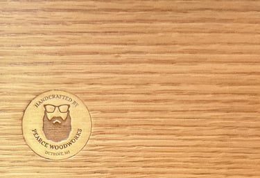 Solid oak with branded woodworker medallion showcasing handmade quality.