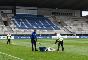 A spotless and organized professional kitchen in a Southern European restaurant, with polished steel surfaces and a bright, clean floor. Detailed focus on sanitation and professional standards.