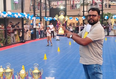 A man on roller skates holding a trophy at Nexus Select Citywalk skating event in Delhi.