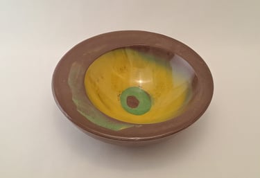 Handmade gypsum bowl featuring a brown rim and glazed yellow interior with green accents.