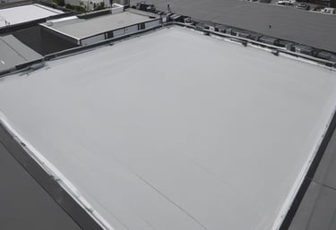 A commercial building under renovation with workers focusing on roofing.