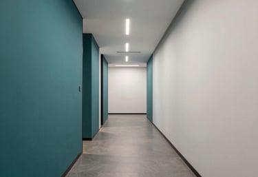 A minimalist, modern corporate corridor in a North American / US office with high-quality materials and professional lighting in teal and off-white.
