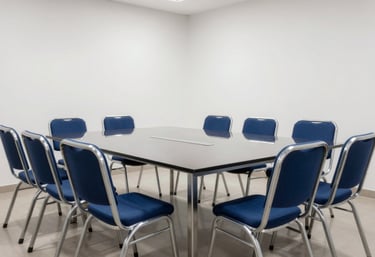 A modern South Asian / Indian meeting room with steel blue chairs and near-white walls, representing a space for transparency and fair negotiations.