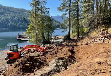 Excavator shaping land for water capture Vancouver Island