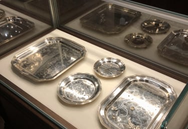 A skilled appraiser carefully examining a vintage silver necklace under bright light.