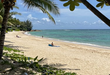 A sleek car parked by the sunny beachside of Golem, ready for a city drive.