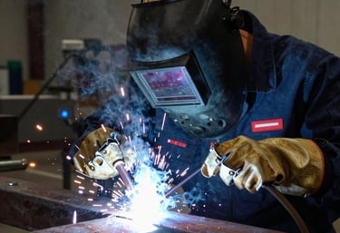 Finished metal clamps and fittings neatly arranged on a workbench.