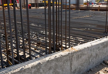 Detail of steel rebar and concrete foundation work at a major infrastructure project site, North American / Mexican industrial style, morning light, engineering precision.