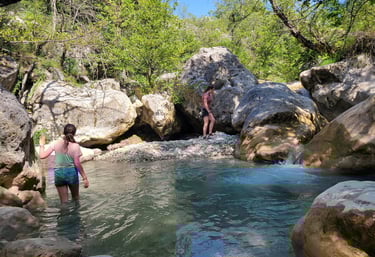 two women standing in a stream of water