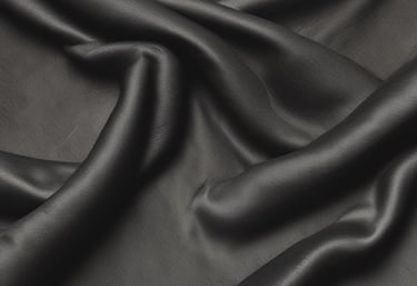 Close-up of rich black than cloth fabric with intricate texture details.