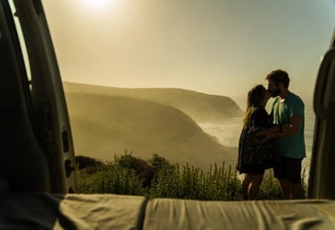 a couple standing in the open door of a van