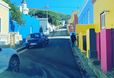 a car driving down a street with a blue sky