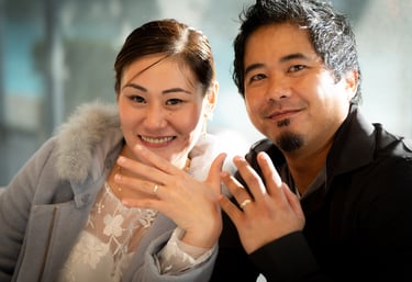 Wedding couple smiling and showing wedding rings