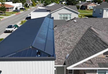 a man riding a skateboard down a street next to tall buildings