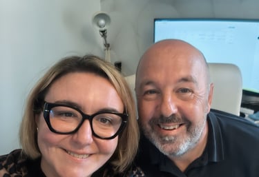 Smiling business colleagues taking a selfie in a modern home office with a computer monitor.
