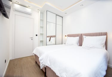 Modern upper floor bedroom with two separable beds and natural light at Villa Aurora Azure
