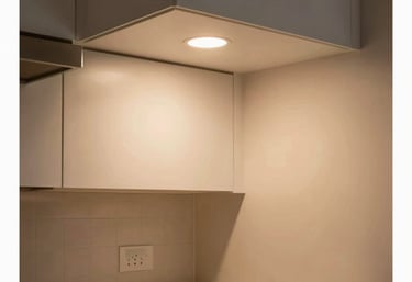 A warmly lit modern North American kitchen with new LED recessed lighting installed under cabinets, creating a clean and comfortable environment.